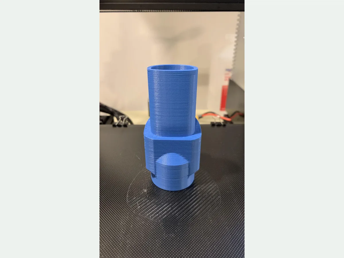 Blue 3D printed adapter joining two different vacuum attachment interfaces