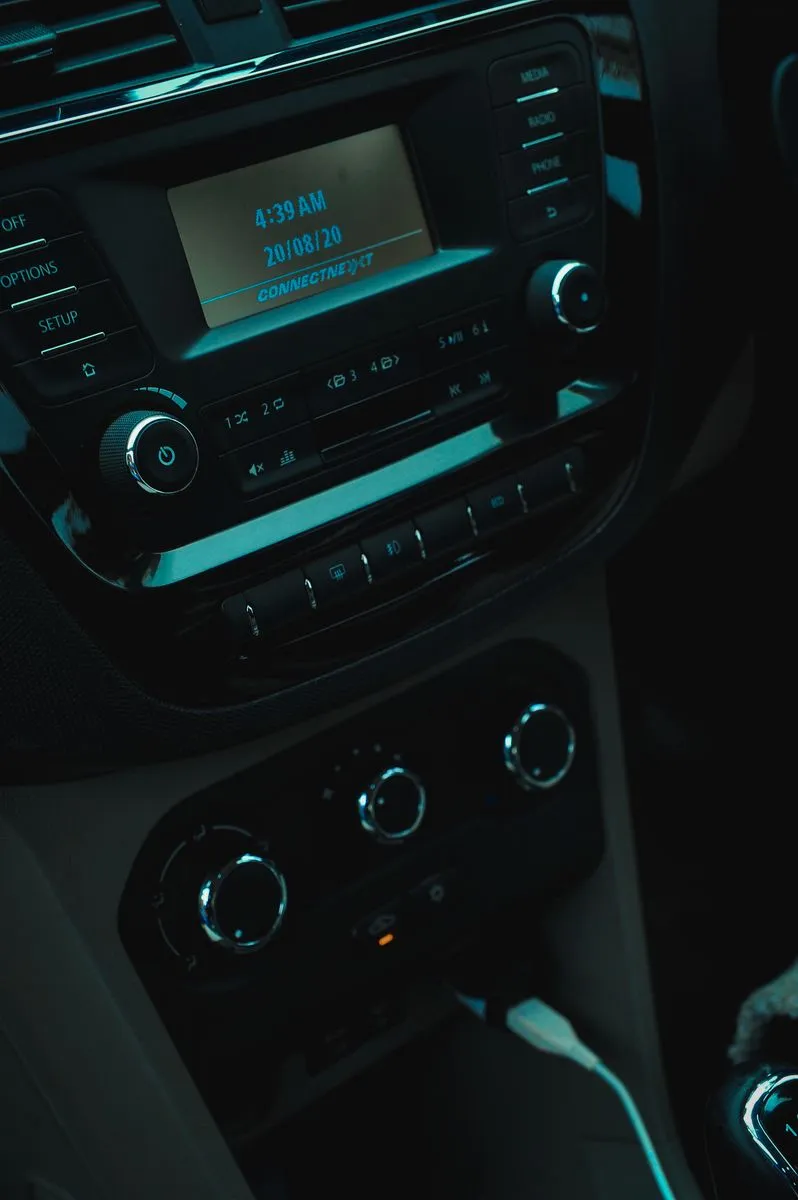 Car stereo, climate controls and dashboard buttons viewed close up