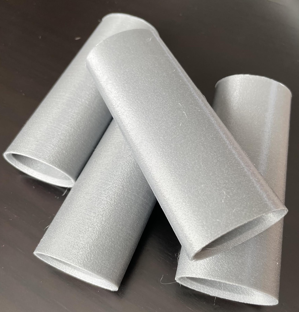 Four grey PETG extension parts printed for CEEQ Design, photographed on the Hark Tech bench before packing