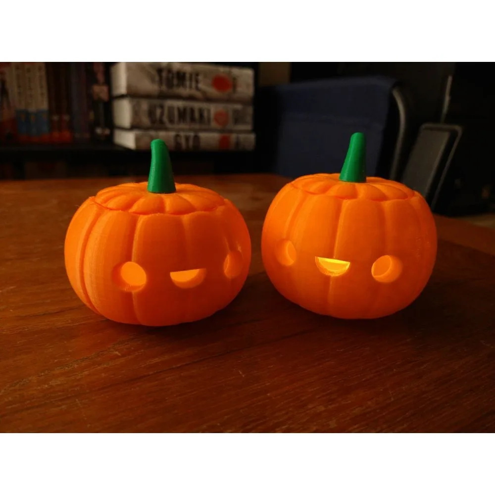 Two orange 3D printed Jack-O-Lantern pumpkins with lids