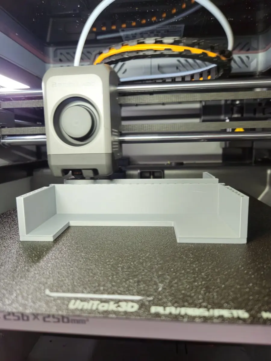 A functional grey part being produced on a Hark Tech 3D printer