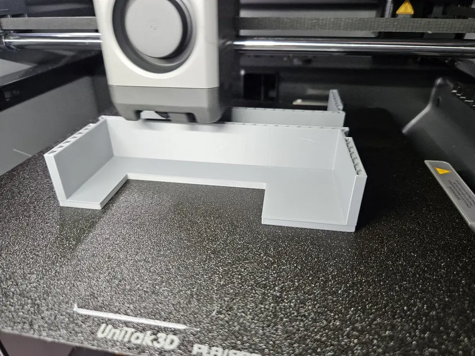 Grey functional 3D printed part being produced on a Hark Tech printer