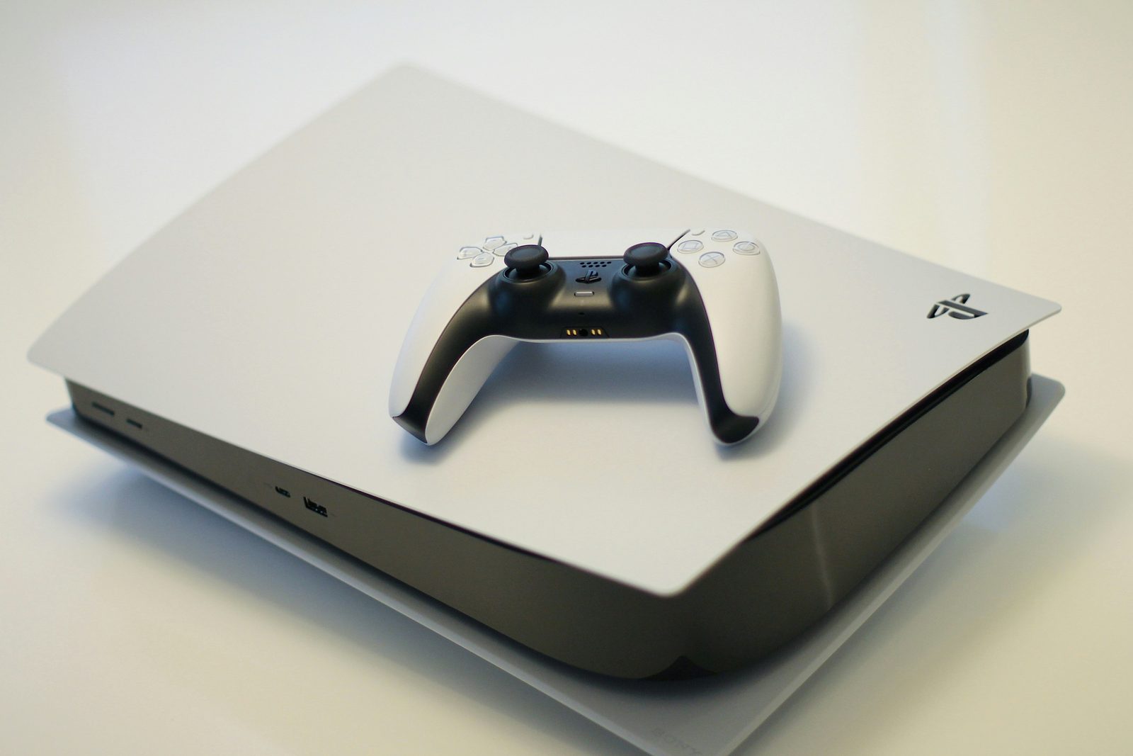 Sony PlayStation 5 console with a white DualSense controller resting on top