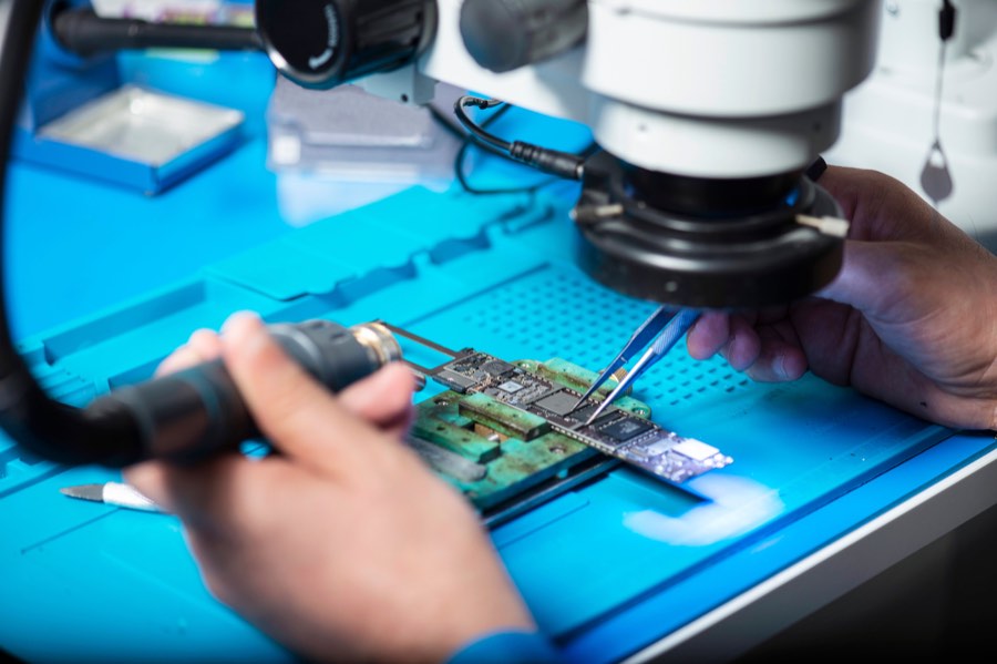 Circuit board being inspected under a microscope