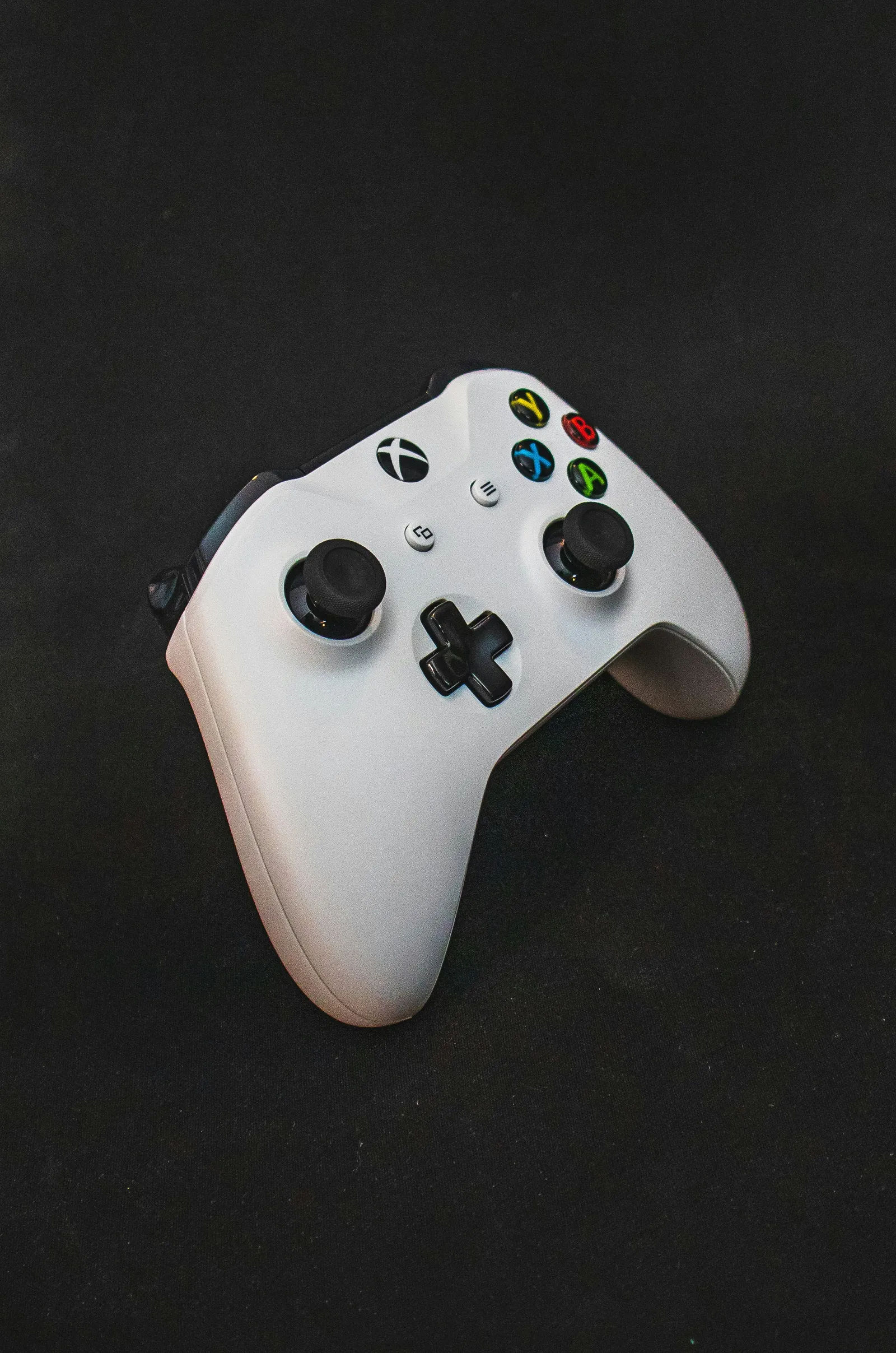 White Xbox controller on a dark surface